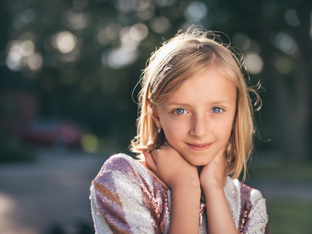selective focus photography of girl in sequined white-and-pink stripe shirt