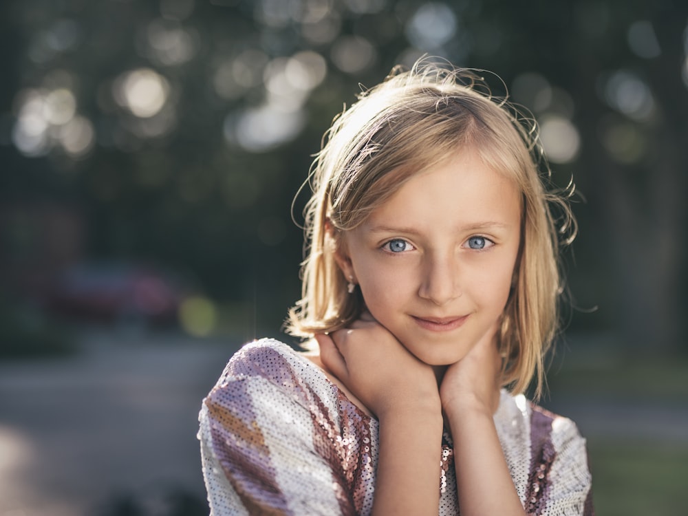 selective focus photography of girl in sequined white-and-pink stripe shirt