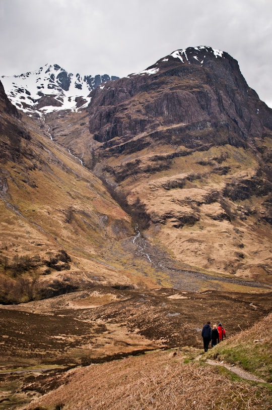 people walking on mountain in Glen Coe United Kingdom