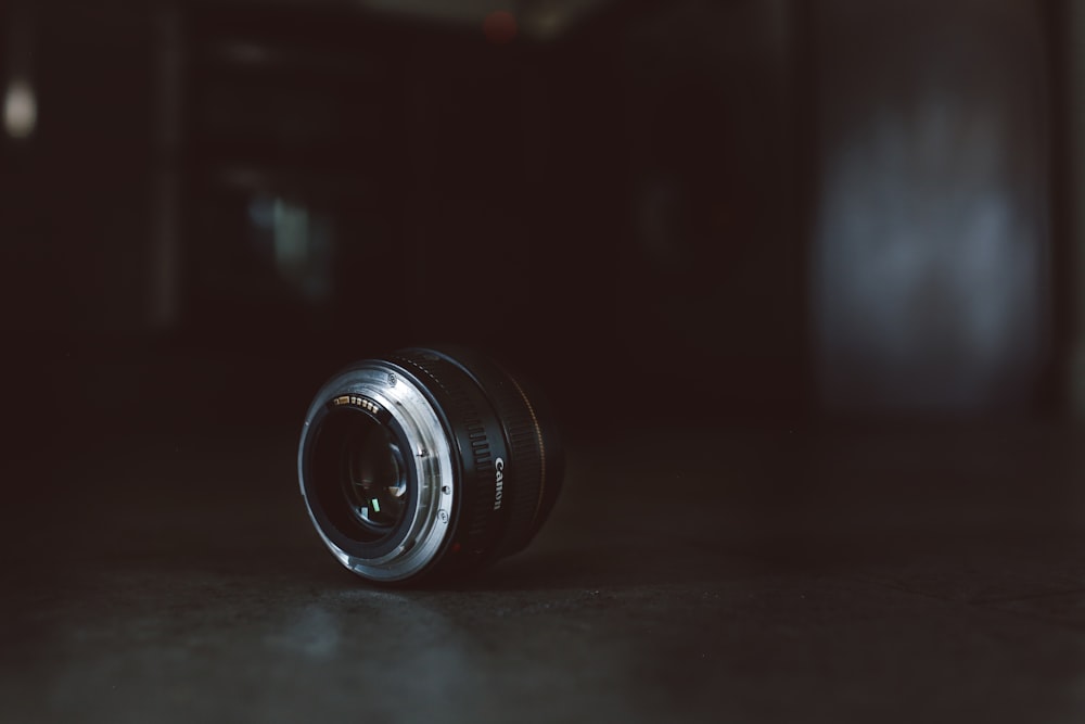 black camera lens on gray surface