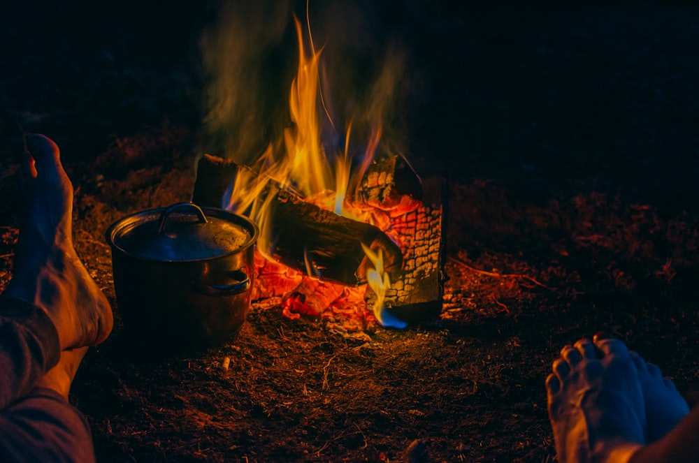 gray steel cooking pot beside the flame