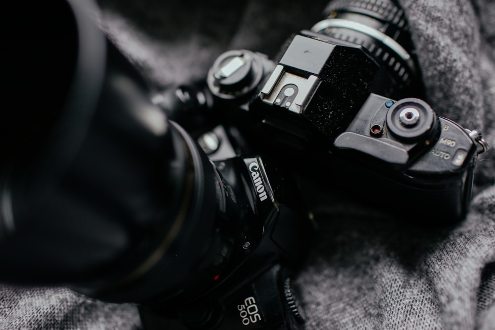 focus photography of two DSLR cameras