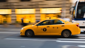tilt shift photography of yellow taxi car