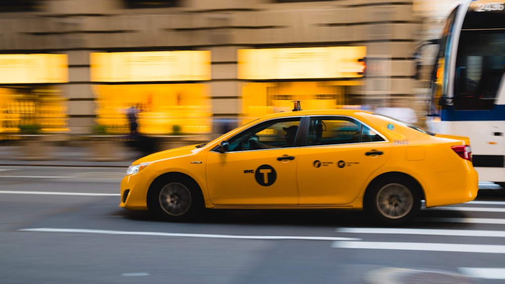 tilt shift photography of yellow taxi car