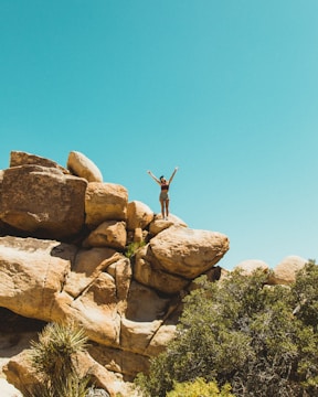 a person standing on top of a rock formation