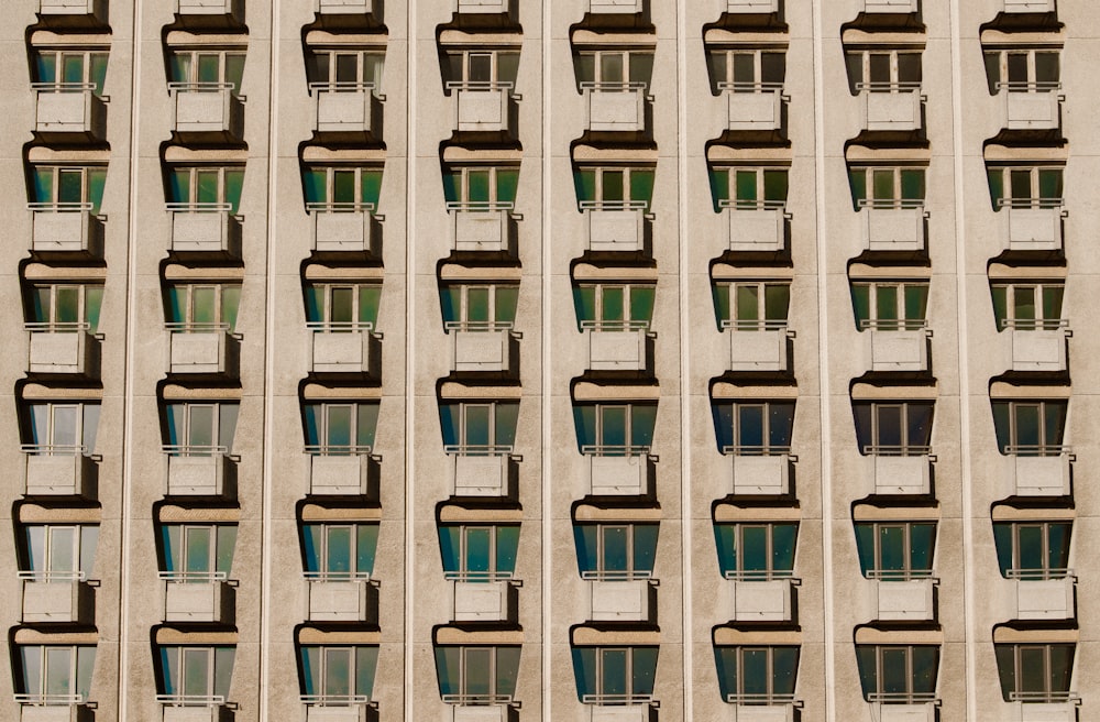 Regular rows of tiny balconies on an old apartment building