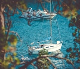 two white yachts on body of water