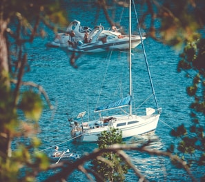 two white yachts on body of water