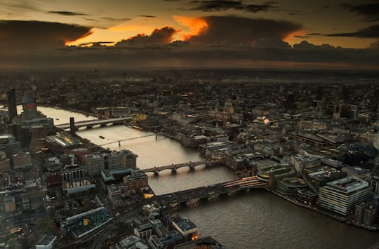 aerial photography of body of water between buildings during golden hour in The Shard United Kingdom