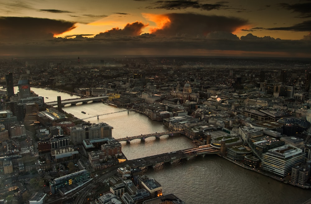 aerial photography of body of water between buildings during golden hour