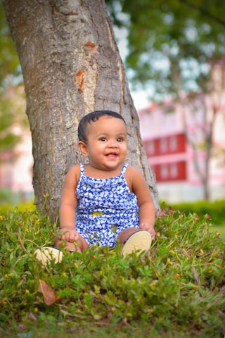 A happy toddler wearing a soft, breathable romper playing outdoors on a sunny day.