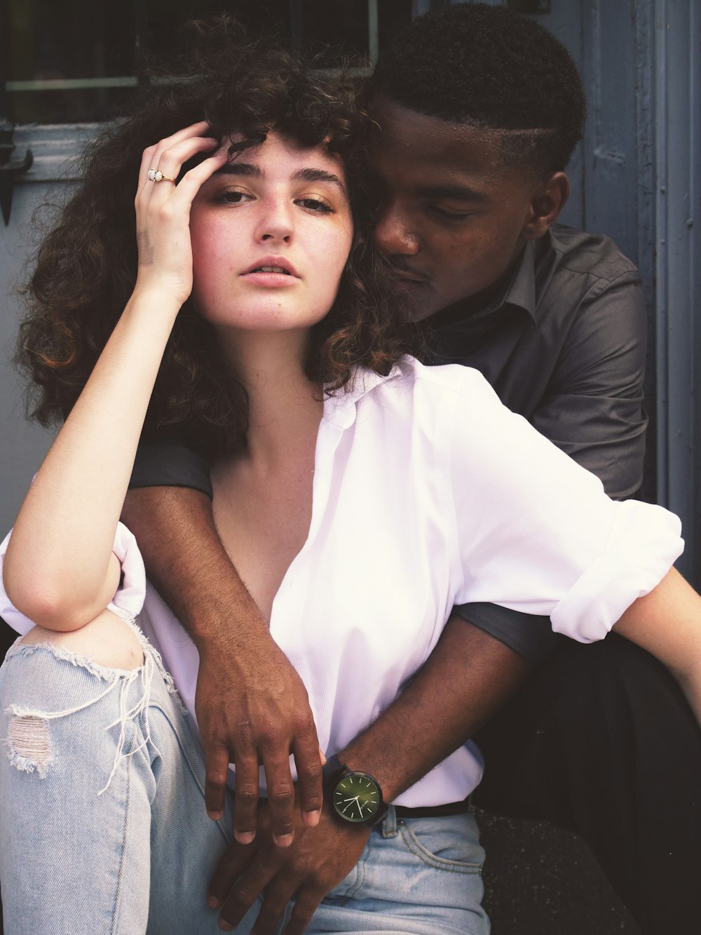 man hugging woman while taking photo of each other