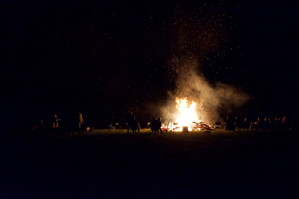 a group of people standing around a fire