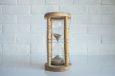 clear hour glass with brown frame