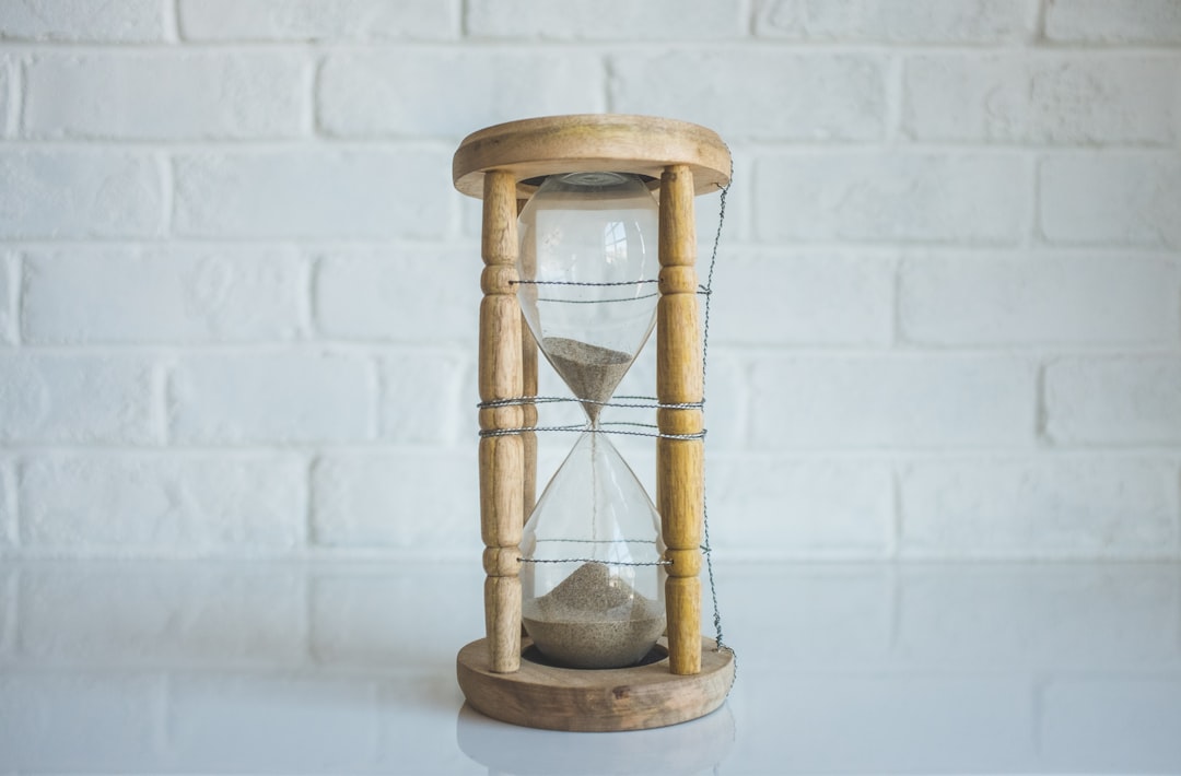 An hourglass with most of its sand on its bottom