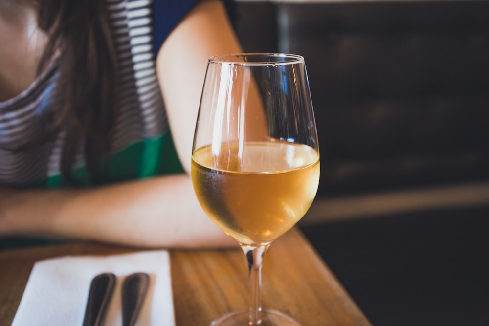 clear wine glass on brown wooden table