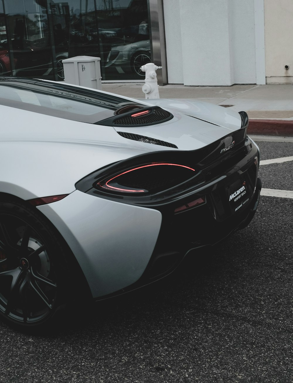 The taillights on a white sports car.