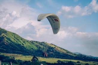 paraglider under blue sky