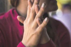 A close-up of hands shaking, symbolizing trust and commitment to people over politics.