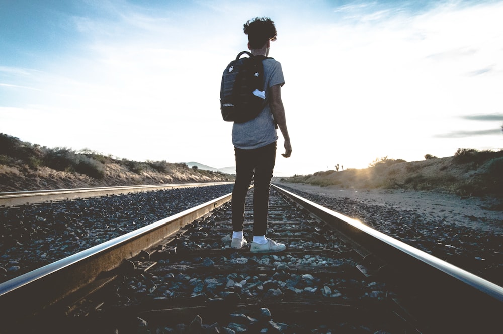 person standing in train rail