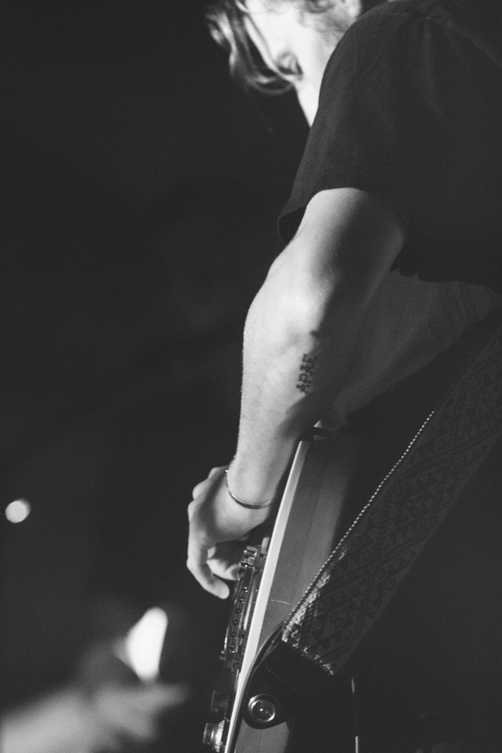 A person strumming a guitar.