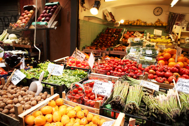 Artisanal food market stall with fresh produce arranged beautifully under soft natural light.