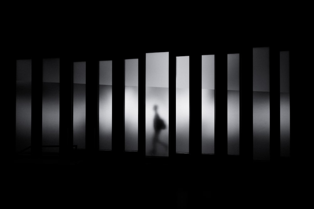 Black and white shot of person silhouette walking in hallway, Museu de Design de Barcelona