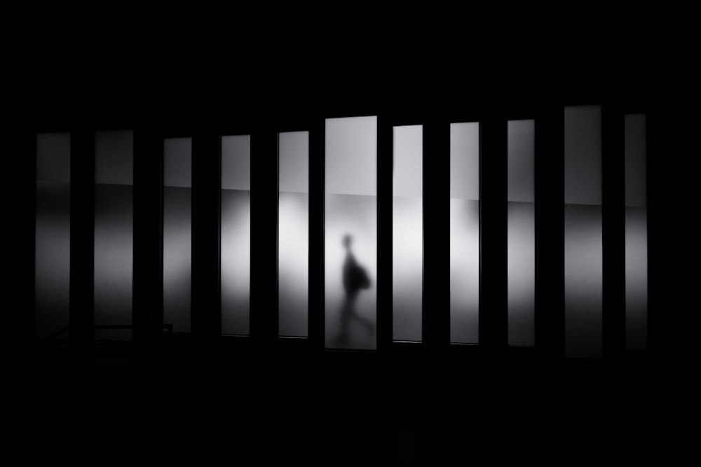 grayscale photo of person running in panel paintings