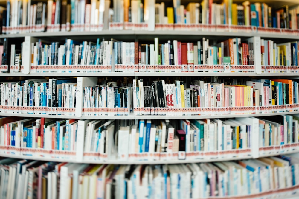 stack of books on bookshelf inside library