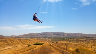 A close-up of a thrilling zip line ride over a beautiful landscape.