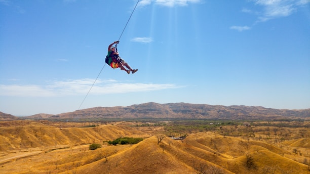 A close-up of a thrilling zip line ride over a beautiful landscape.