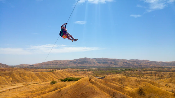 Thrilling zip-line ride over a scenic canyon with smiling adventurers