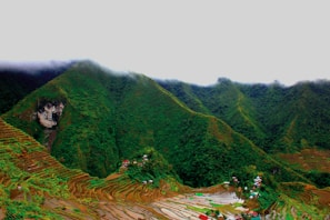 Misty mountain peaks rising above lush green valleys in Sapa.