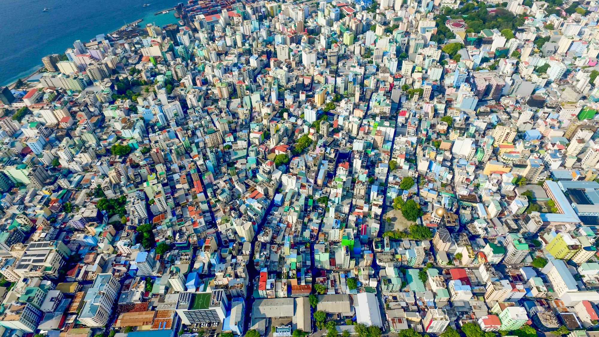 With a population of almost 400,000 in Maldives Male’ houses occupies about 200,000 people including foreign workers. As the local islanders finish their 10th or 12th grade they are somehow  forced to come to city for their higher educations and to look for better opportunities. Its really sad to have one single city developed over 30 years instead of developing islands in different locations in Maldives. The current situation could have been avoided. I hope to see 5 more cities like this in Maldives in different locations so that one place won’t get packed. It’s beautiful from the Sky.