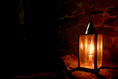 A softly glowing lantern casting warm light in a rustic room.