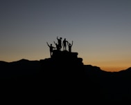 silhouette of people standing on highland during golden hours