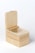 A wooden box with smooth edges and a latch on top. The box is open, revealing a round compartment inside. The wood has a light, natural finish with visible grain patterns.
