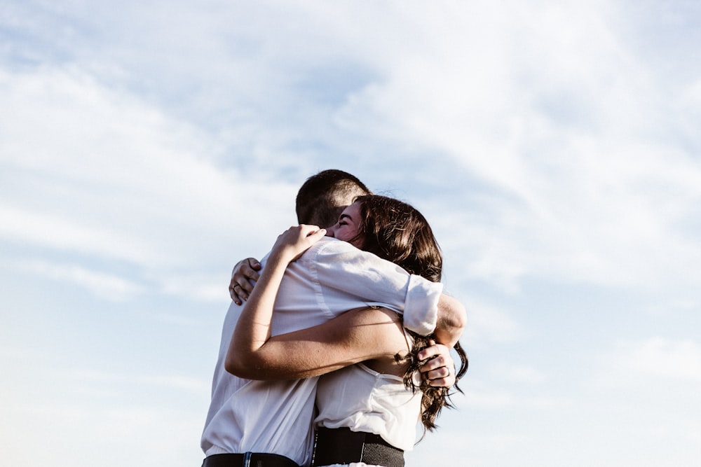 man and woman hugging each other photography