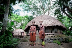 two men standing near house