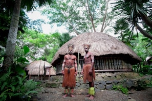 two men standing near house