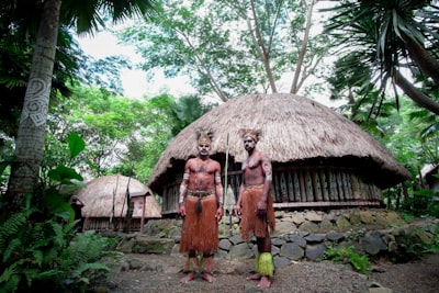 two men standing near house traditional teams background