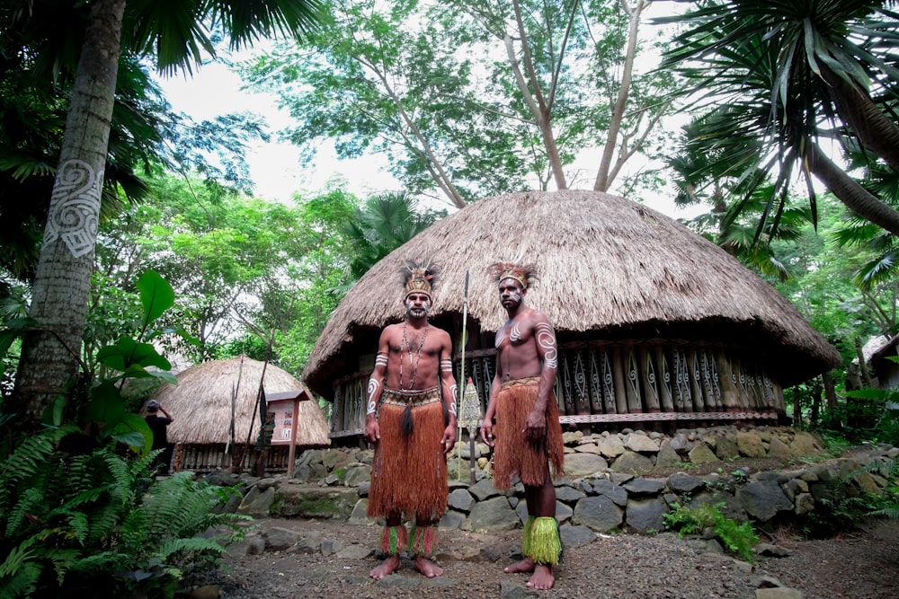 two men standing near house