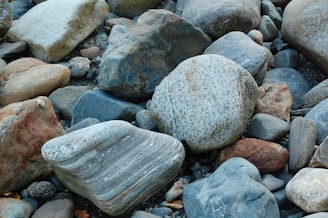 Fragmented rock pieces neatly arranged after blasting operation.