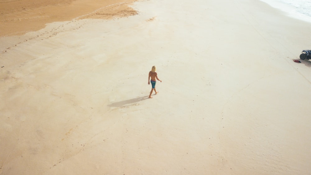 person walking on beach