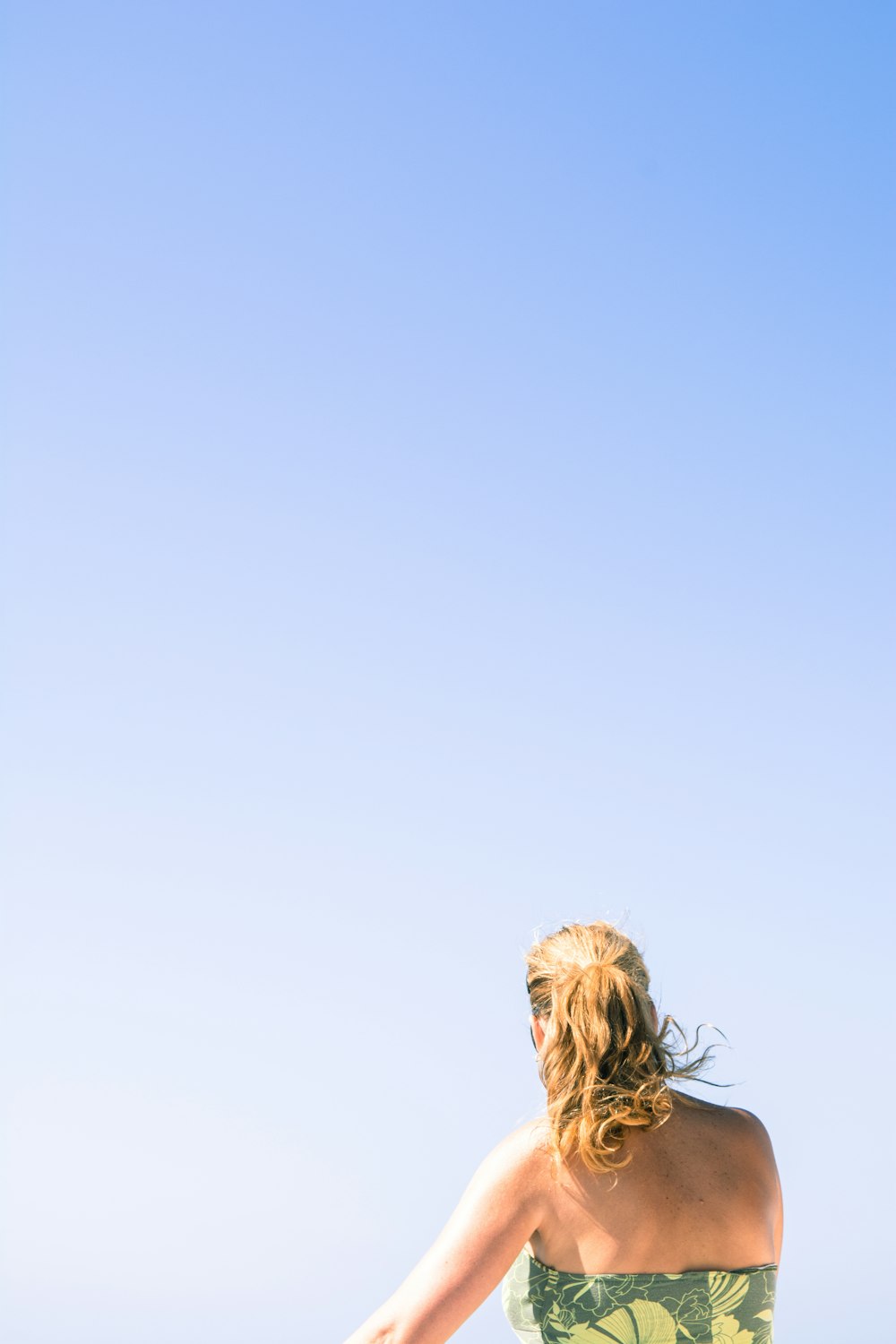 back view of woman wears green strapless dress