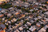 An aerial shot of a vibrant neighborhood with mixed residential buildings and green spaces.