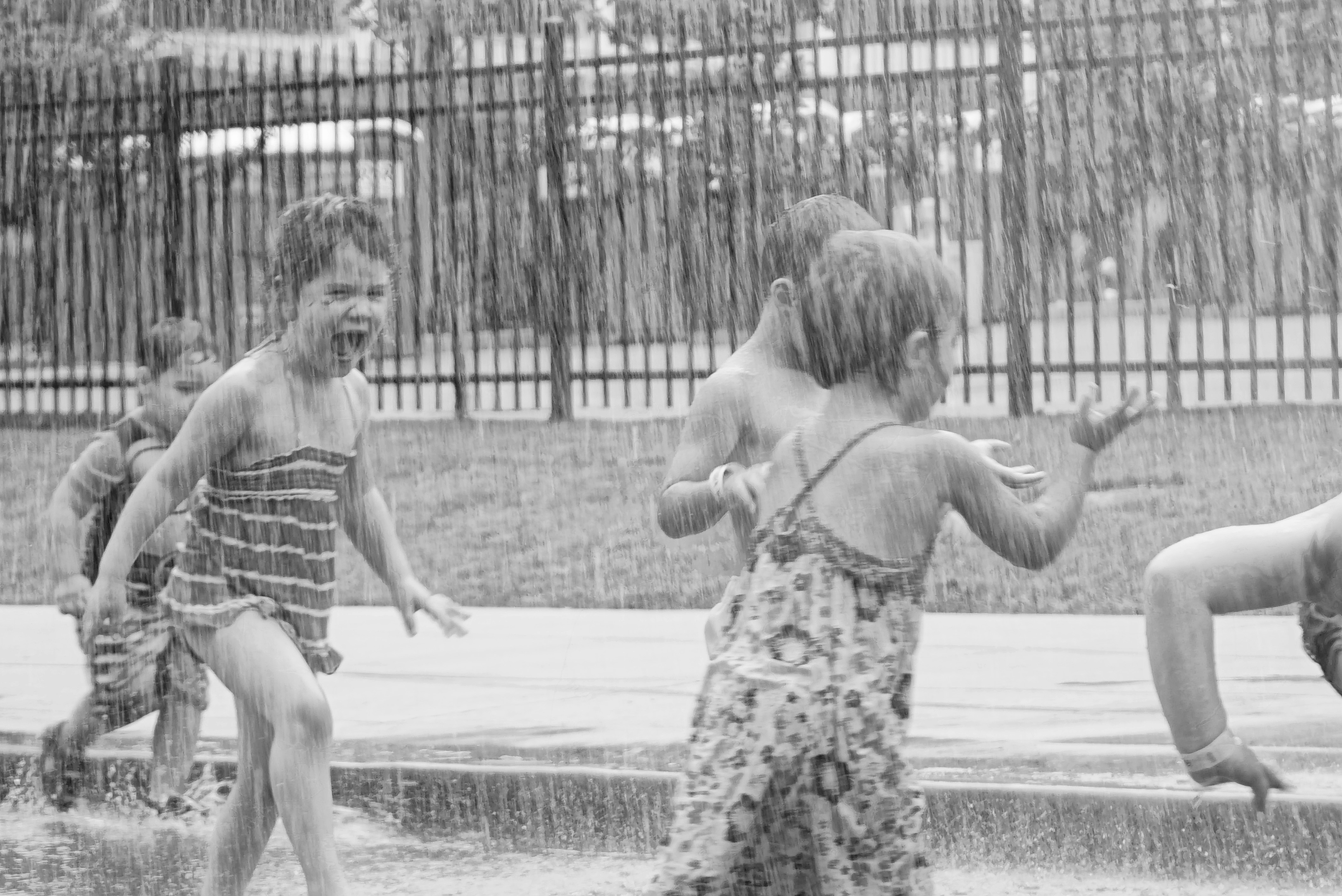 Children playing joyfully in a garden, surrounded by vibrant flowers and greenery.