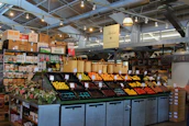 Friendly staff sorting fresh produce in a bright warehouse filled with natural light.