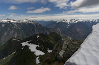 A panoramic view of the Swiss Alps with snow-capped peaks and green valleys.