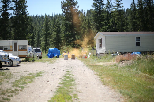 Freshly graded driveway leading up to a new home in a rural setting.